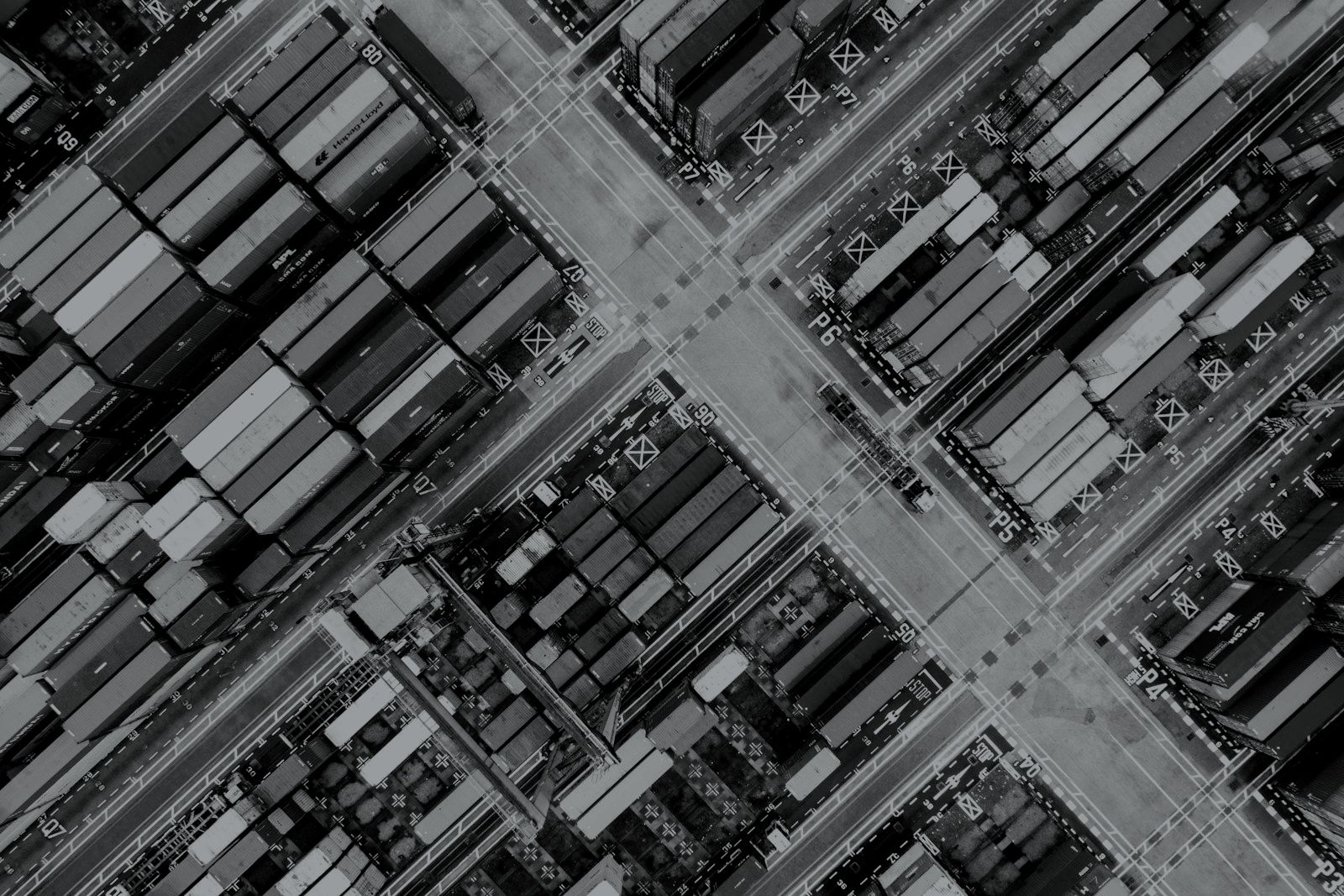 Aerial view of a container terminal, rendered in black and silver